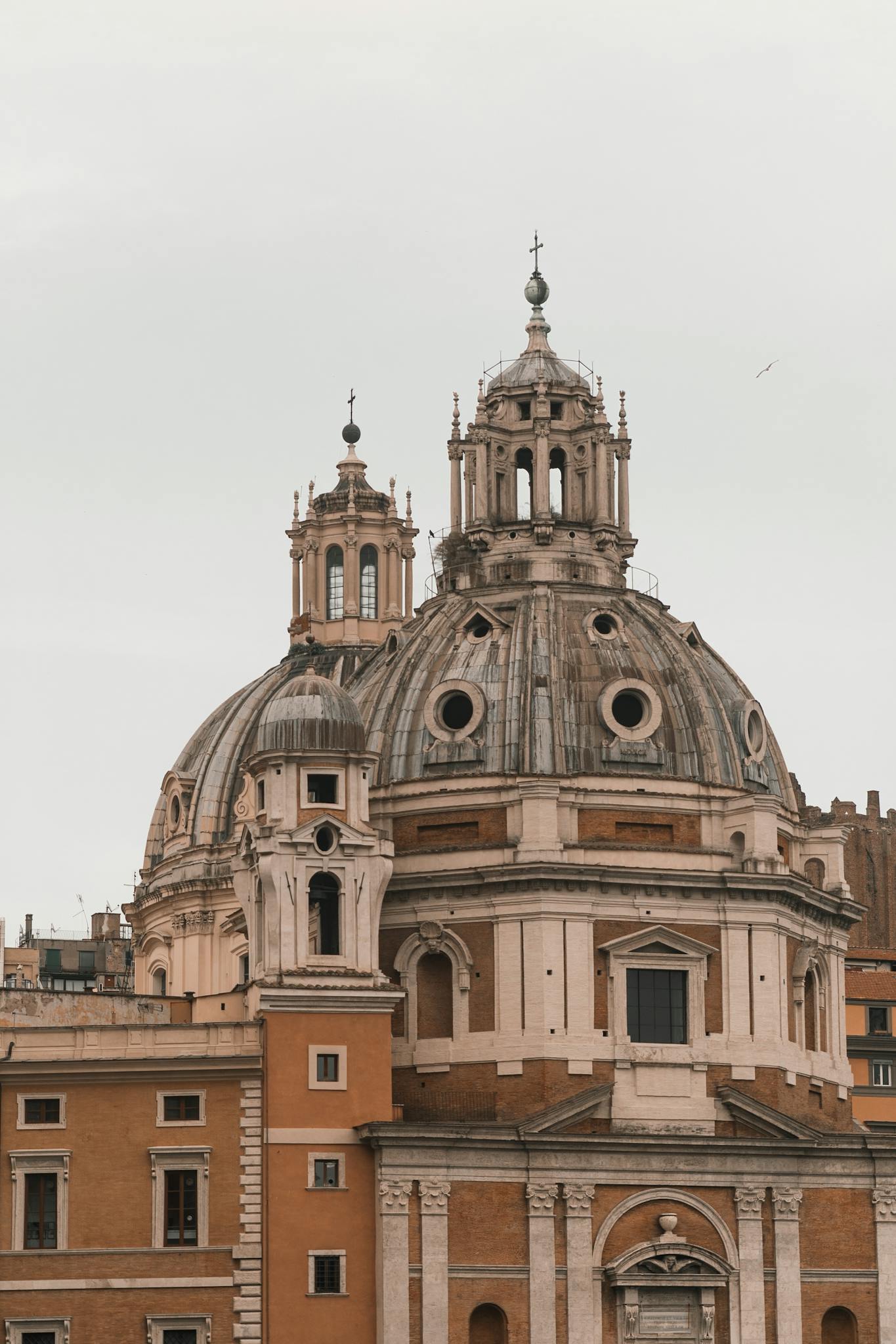 Exterior of aged famous cathedral with large dome and ornate decorative elements in overcast weather